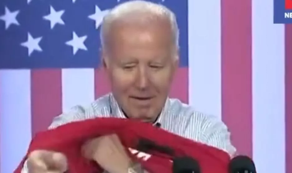 Joe Biden attempts to put his T shirt on at a rally 5058799